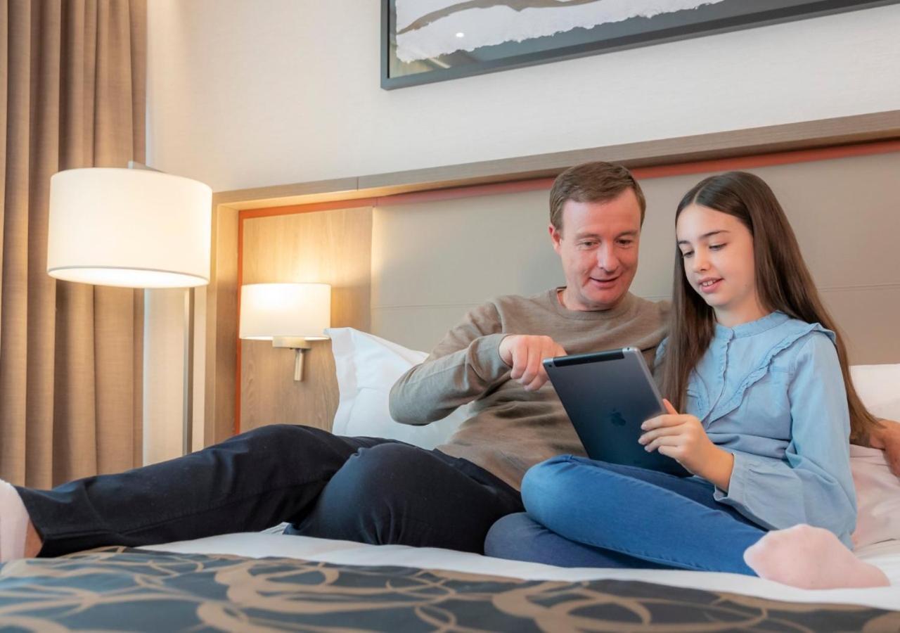 Clayton Hotel Dublin Airport Coolock Bagian luar foto A father and daughter playing with a tablet