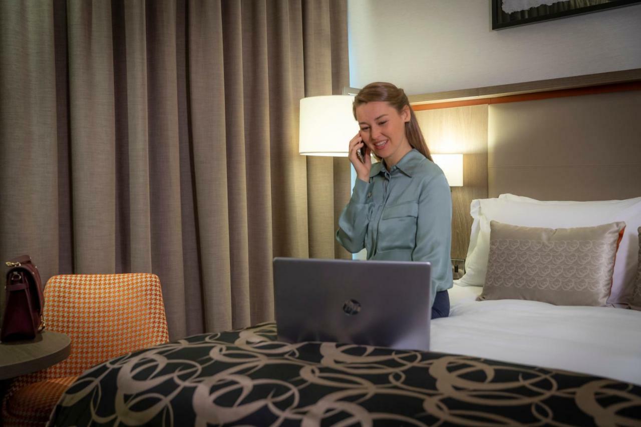 Clayton Hotel Dublin Airport Coolock Bagian luar foto A woman working from home.